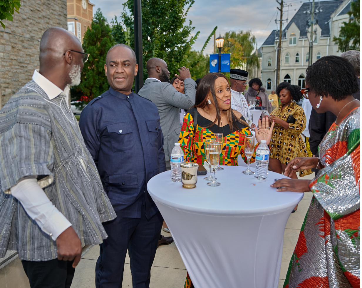Members in traditional attire connecting at a 6Africa reception